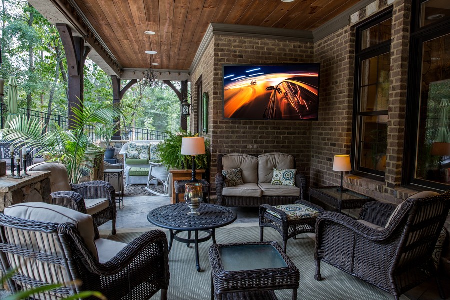 An outdoor TV mounted on a wall as part of outdoor entertainment setup on a St. Louis patio. 
