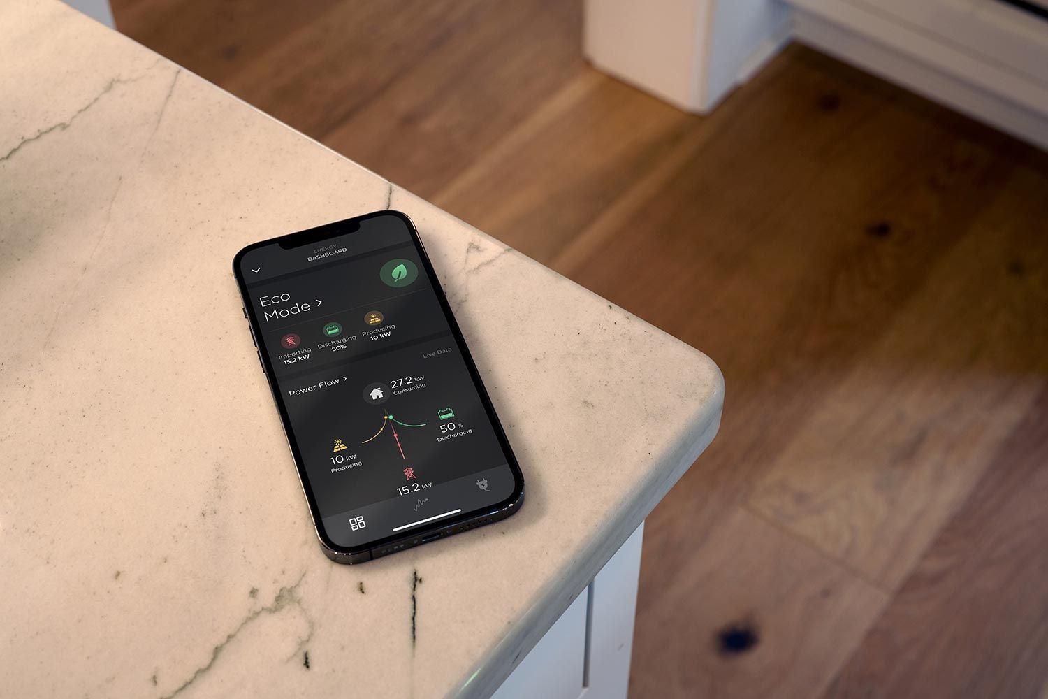Smartphone with an energy dashboard placed on a kitchen counter